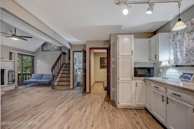 1148 Country Place Dr, Tobyhanna, PA 18466 - kitchen featuring light wood-type flooring, white cabinets, open floor plan, and a ceiling fan