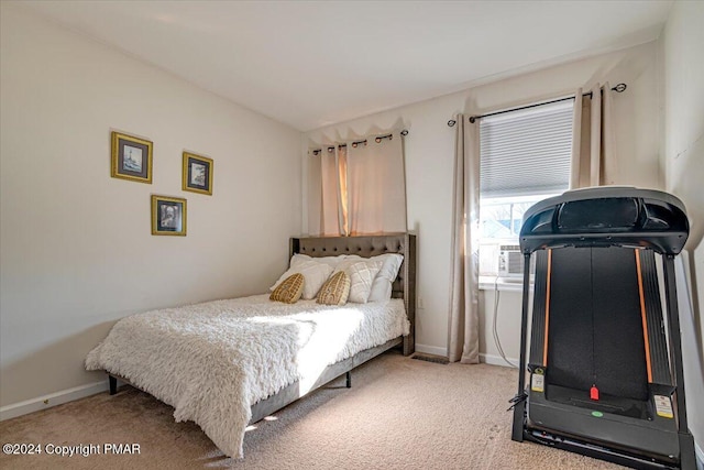 carpeted bedroom featuring cooling unit and baseboards