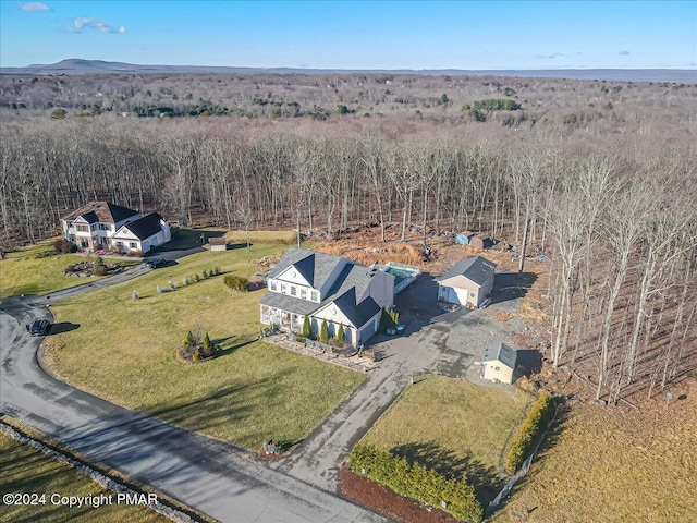 birds eye view of property with a view of trees