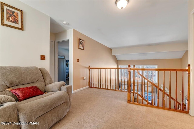 sitting room featuring carpet flooring and baseboards