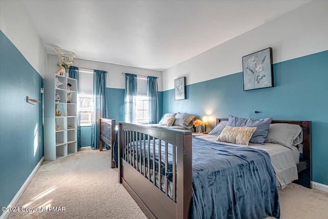 carpeted bedroom featuring baseboards