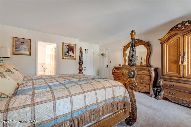 carpeted bedroom featuring ensuite bath