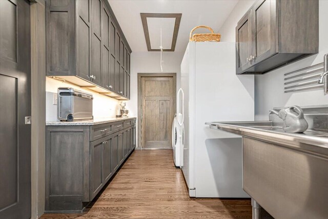 115 Ridgewood Ln, Hawley, PA 18428 - kitchen featuring freestanding refrigerator, wood finished floors, light countertops, and a sink