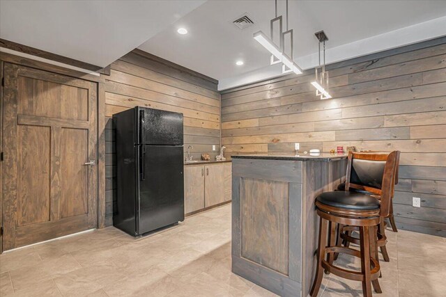 115 Ridgewood Ln, Hawley, PA 18428 - indoor dry bar featuring freestanding refrigerator, wood walls, hanging light fixtures, light tile patterned flooring, and recessed lighting