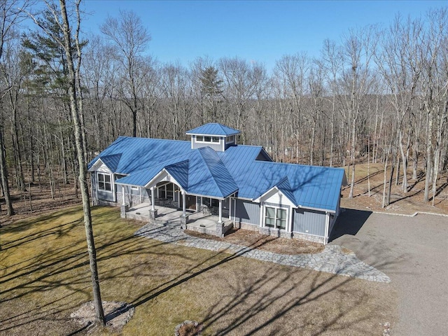 115 Ridgewood Ln, Hawley, PA 18428 - view of front facade featuring a porch, metal roof, a view of trees, and a standing seam roof
