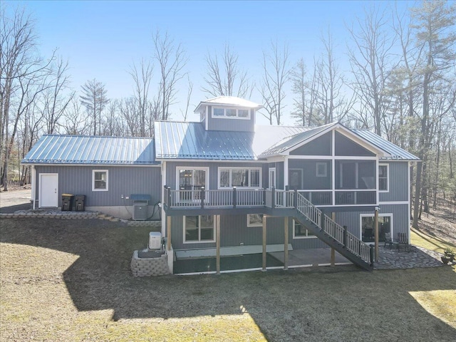115 Ridgewood Ln, Hawley, PA 18428 - rear view of house featuring metal roof, stairway, a sunroom, and a yard