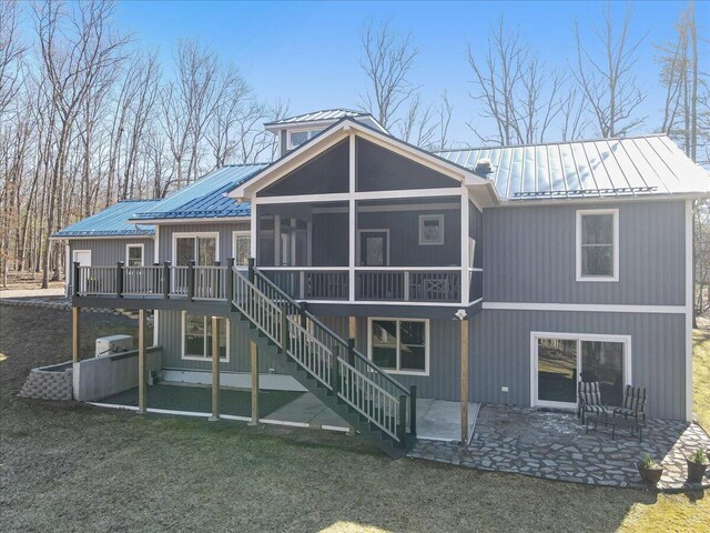 115 Ridgewood Ln, Hawley, PA 18428 - back of property featuring metal roof, a patio area, a standing seam roof, and a yard