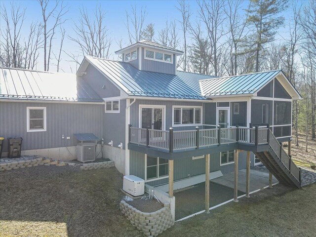 115 Ridgewood Ln, Hawley, PA 18428 - back of house with a standing seam roof, a sunroom, metal roof, stairs, and a deck