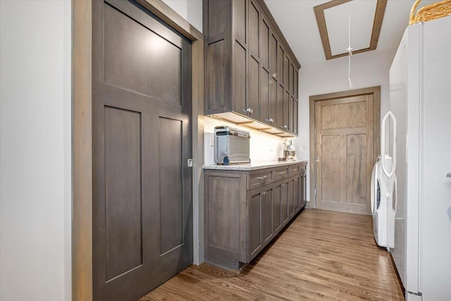 115 Ridgewood Ln, Hawley, PA 18428 - laundry room with attic access, washing machine and clothes dryer, wood finished floors, and cabinet space