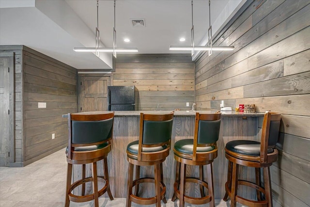 115 Ridgewood Ln, Hawley, PA 18428 - indoor dry bar with freestanding refrigerator and wood walls
