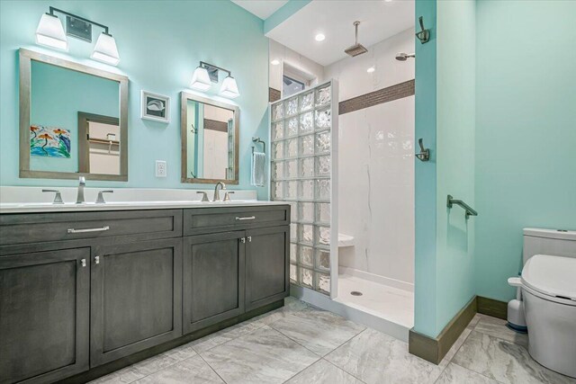 115 Ridgewood Ln, Hawley, PA 18428 - bathroom with marble look tiles, toilet, a walk in shower, double vanity, and baseboards