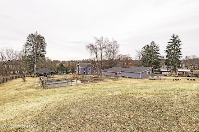 view of yard with an outbuilding and fence