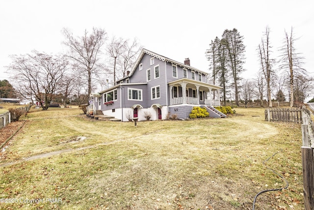 view of side of home featuring a yard and a porch