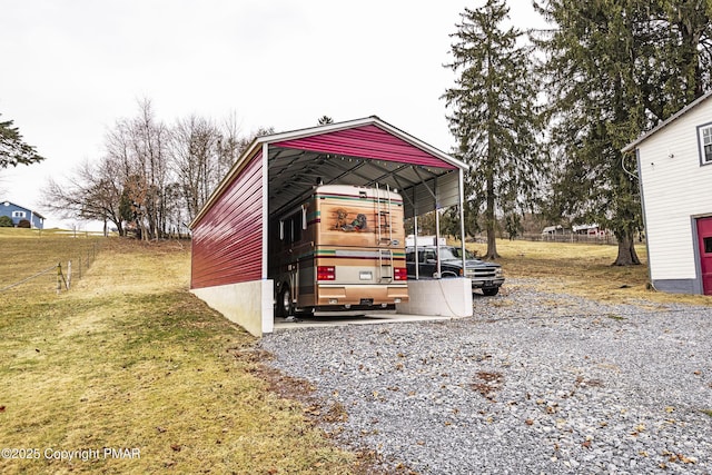 view of outdoor structure featuring a carport and a lawn