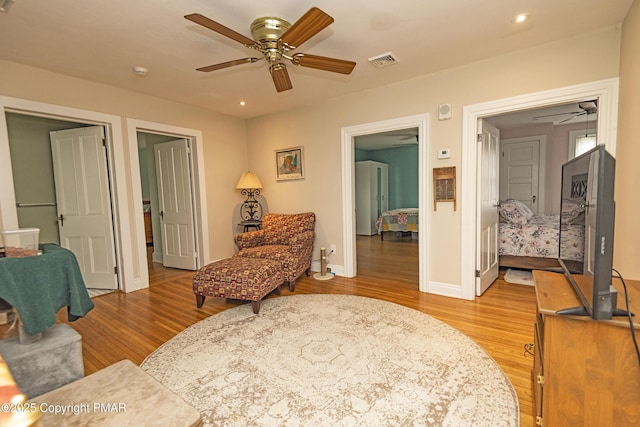 sitting room with recessed lighting, a ceiling fan, baseboards, visible vents, and light wood-style floors