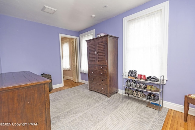 bedroom with light wood-style floors and baseboards