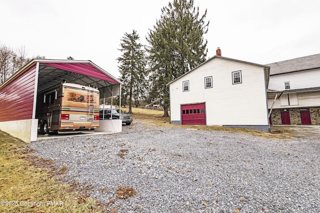 view of side of home with a carport