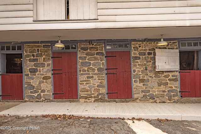 doorway to property featuring stone siding