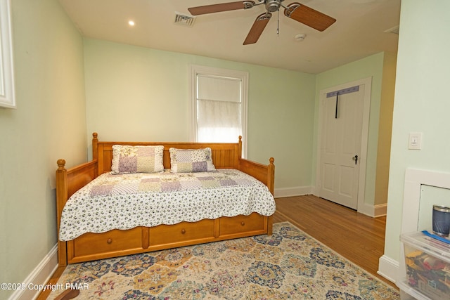 bedroom with ceiling fan and light hardwood / wood-style floors