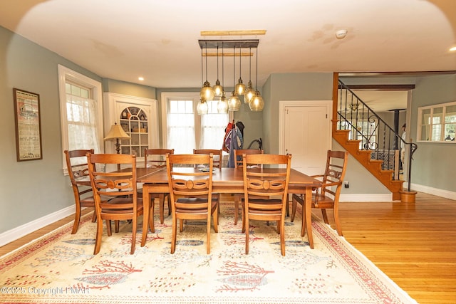 dining space featuring stairs, recessed lighting, baseboards, and wood finished floors