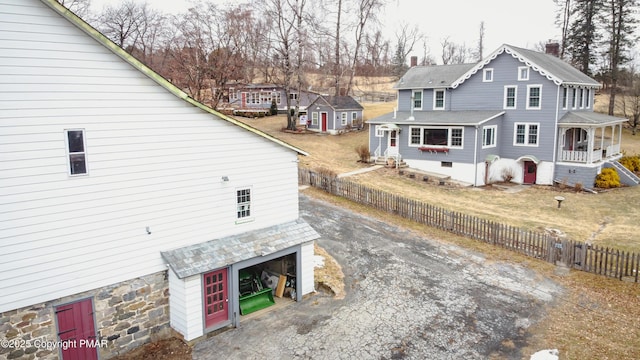 view of home's exterior with driveway and fence