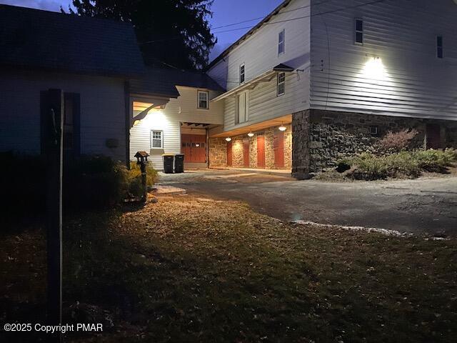 view of property exterior with a garage and driveway