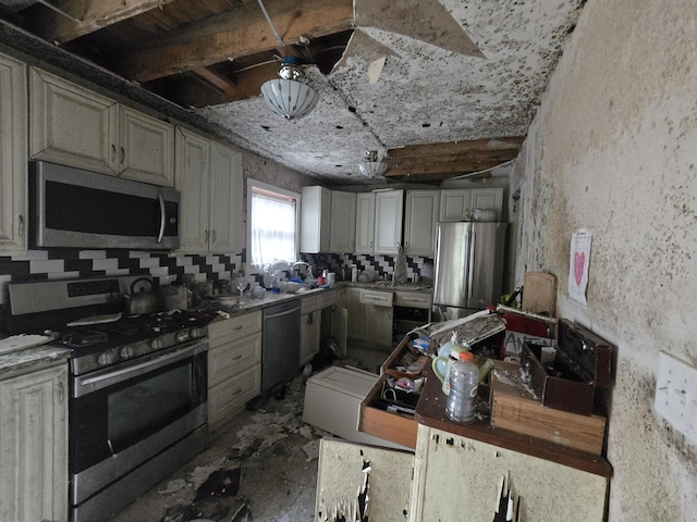 kitchen with a sink, appliances with stainless steel finishes, and backsplash