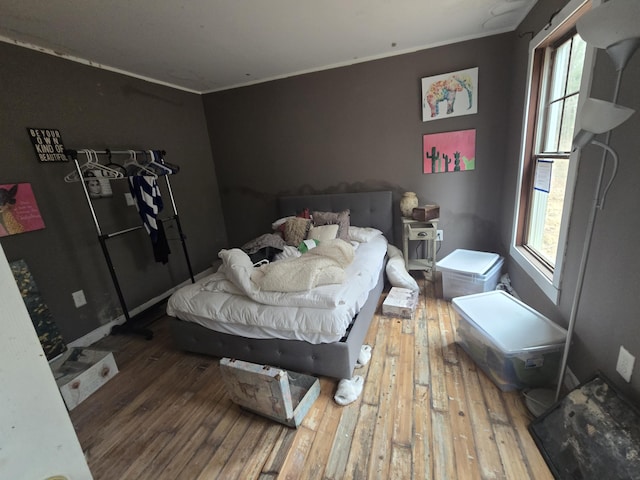 bedroom featuring crown molding and hardwood / wood-style flooring