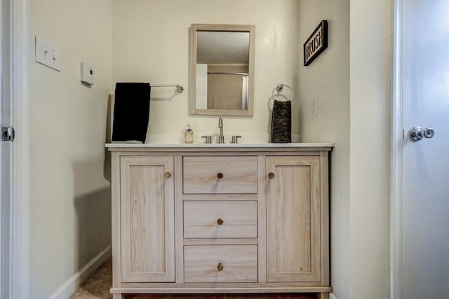 bathroom with vanity and baseboards