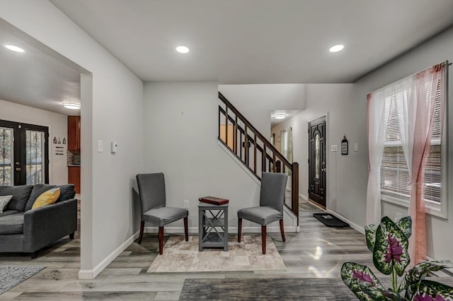 foyer entrance with recessed lighting, baseboards, light wood-style flooring, and stairs