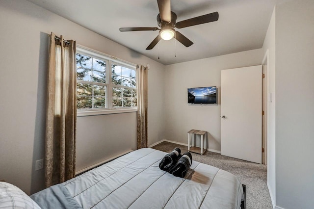 bedroom featuring baseboards, a ceiling fan, and carpet