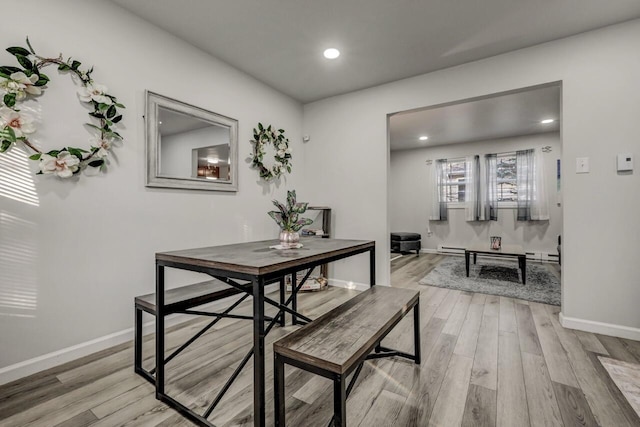 dining space featuring recessed lighting, light wood-type flooring, baseboards, and a baseboard radiator