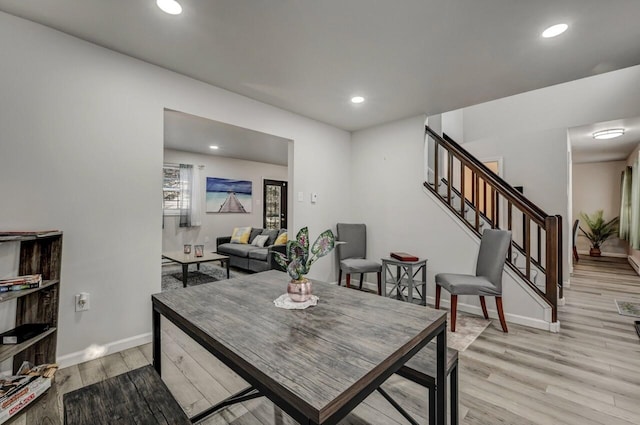 dining area featuring stairway, recessed lighting, baseboards, and light wood finished floors