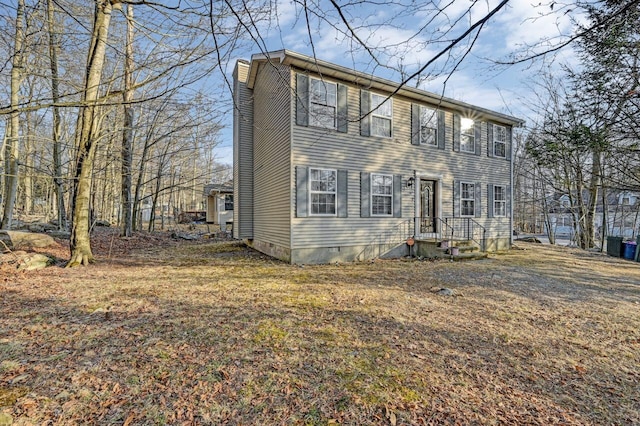 colonial-style house with a chimney and crawl space