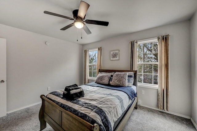 bedroom with light colored carpet, baseboards, and ceiling fan