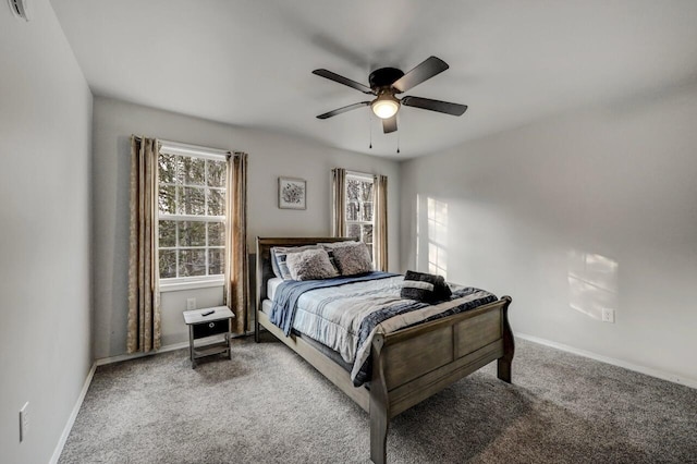 carpeted bedroom featuring baseboards and ceiling fan