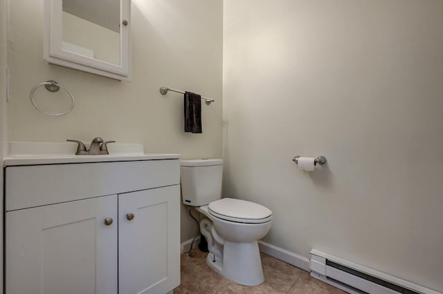 half bathroom featuring a baseboard heating unit, baseboards, toilet, tile patterned floors, and vanity