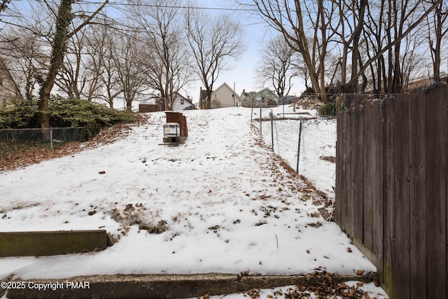 yard covered in snow with fence