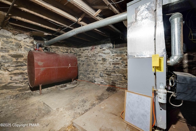 unfinished below grade area featuring heating unit and heating fuel