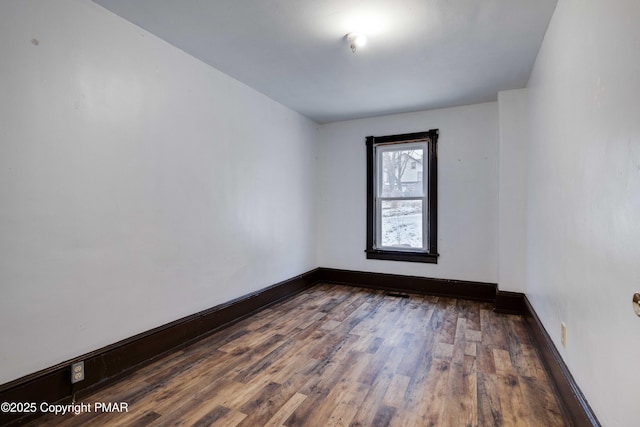 empty room with wood finished floors and baseboards