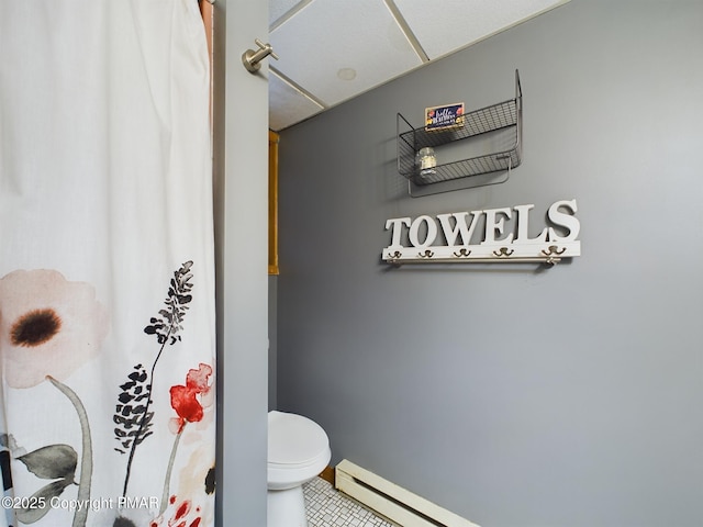 bathroom with a baseboard radiator and toilet