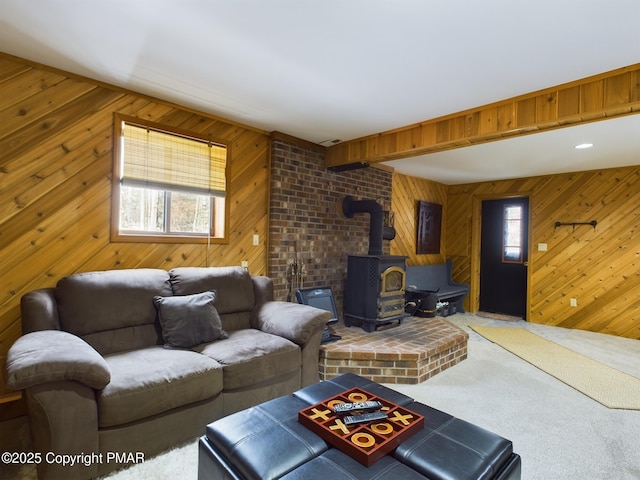 living room featuring carpet floors and a wood stove