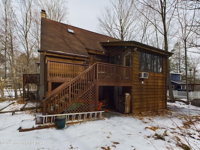 snow covered property featuring a wooden deck