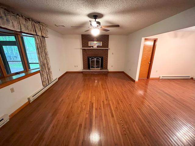 268 Kestel Dr, Kunkletown, PA 18058 - unfurnished living room with a baseboard radiator, hardwood / wood-style flooring, a ceiling fan, a textured ceiling, and baseboards