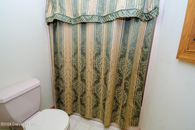 bathroom featuring tile patterned floors and toilet