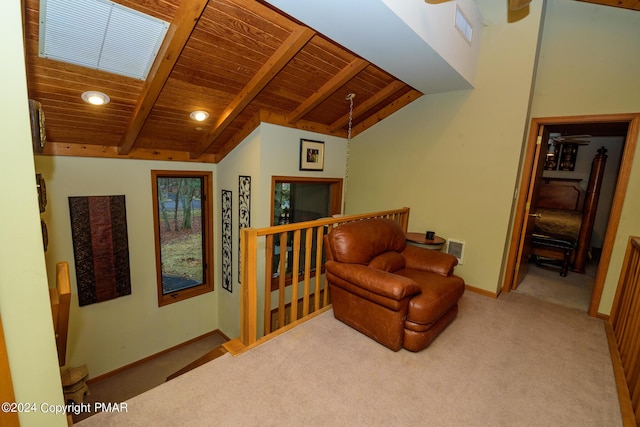 sitting room with visible vents, an upstairs landing, baseboards, wood ceiling, and vaulted ceiling with beams