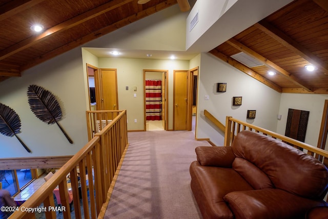 corridor with visible vents, an upstairs landing, wooden ceiling, carpet flooring, and vaulted ceiling with beams