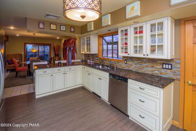 kitchen with visible vents, dark wood-type flooring, a peninsula, white cabinets, and stainless steel dishwasher