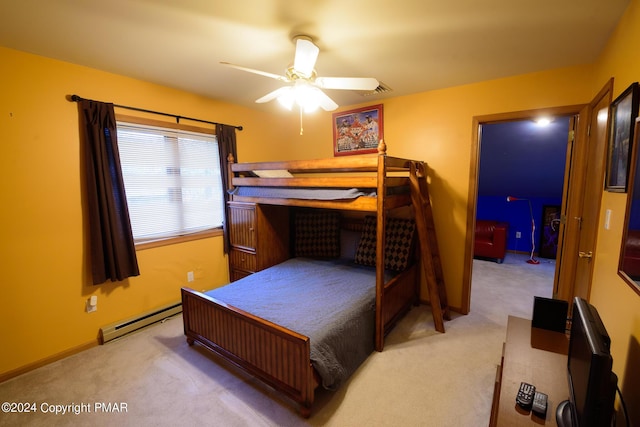 bedroom with a baseboard heating unit, light colored carpet, baseboards, and a ceiling fan