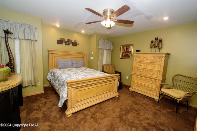 bedroom featuring baseboards, dark colored carpet, and ceiling fan